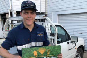 Meet Levi - holding his new business sign in front of his ute.